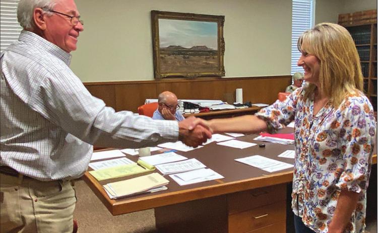 Stonewall County Judge Ronnie Moorhead shakes the hand of Darla Pearson after swearing her in as the new Stonewall Justice of the Peace.