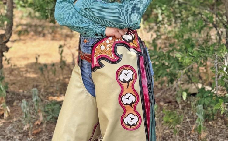 2025 FCFR Queen Berklee Pippin showing off the chaps that will be passed down to the 2026 Rodeo Royalty Court