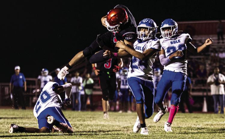 Top: Aspermont's Caleb Broshears brushes off Bobcat defenders to gain a first down during the Hornets 66-22 win over Rule last Friday night. The Hornets kick off district play 1-0 and will next face Lueders-Avoca in Lueders this Thursday night at 7pm PHOTO BY: MARK MARTINEZ