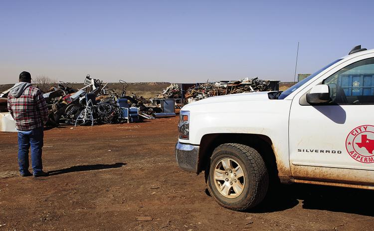 Aspermont City Manager Lorenzo Calamaco looks out over two, 40-yard containers worth of scrap metal that was recently declined for salvage after testing positive for radiation. (PHOTO BY TRICIA HURT)