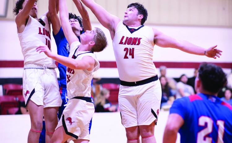 Left: Roby senior Chasity Benson puts up a shot of over a Houndette defender during the Lady Lions' 50-9 routing of Knox City Tuesday night. The Lady Lions are one step closer to a district championship pending a potential win against the Aspermont Lady Hornets this Friday in Aspermont. PHOTO BY: TRICIA HURT
