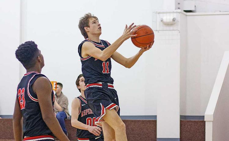 Aspermont Hornet Olen Johnson gets an easy layup in last Friday's gaem against Paint Creek. (Photo by Mark Martinez)