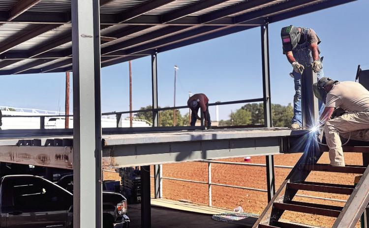Workers construct the steel frame for a new seating area at the Fisher County rodeo grounds ahead of the 82nd annual Fisher County Fair and Rodeo. The two-level structure is part of several improvements underway at the grounds as organizers prepare for this year’s event.