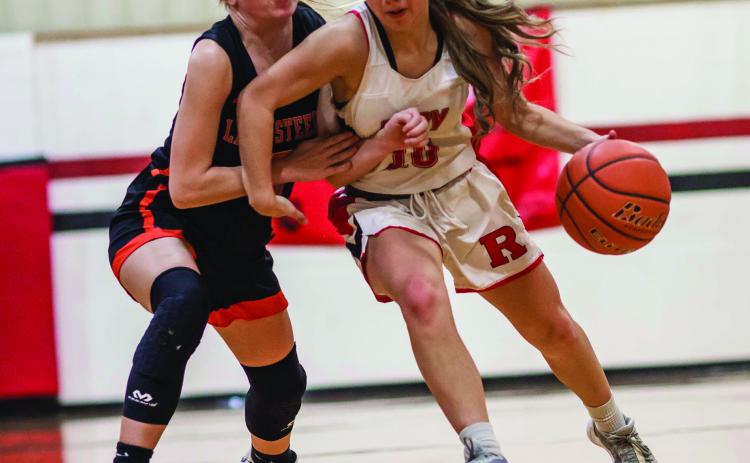 Roby Junior Lilly Benson battles with a Lady Steer defender during the Lady Lion's close 27-- 34 loss to Robert Lee Tuesday night. The Lady Lions will begin this district play this Friday at home against Lueders-Avoca. PHOTO BY MARK MARTINEZ