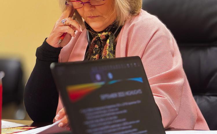 Stonewall Memorial Hospital District Board President Ellen Abernathy listens as CFO Lew Robbins presents the district’s September financial report during the board’s regular November meeting. PHOTO BY JEFF HURT