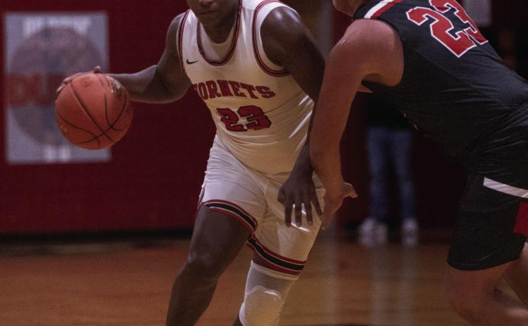 Aspermont senior Donovan Miller dribbles through a Tiger defender during the Hornets 55-38 win over Anson Tuesday night. (Photo by Mark Martinez)