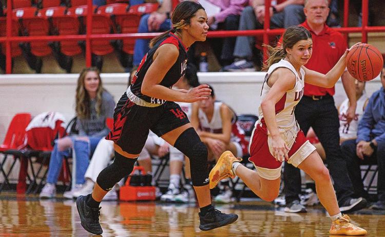 Lilly Benson fast breaks down the court during Friday's 72-8 win over the Lady Raiders. Photo by: Mark Martinez
