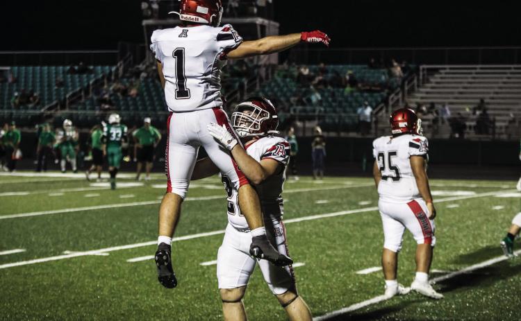 Senior Mason Brannan (right) lifts teammate Kolby Bradshaw (Left) in celebration after a touchdown during last Friday's week 1 win over Blackwell. PHOTO BY: MARK MARTINEZ