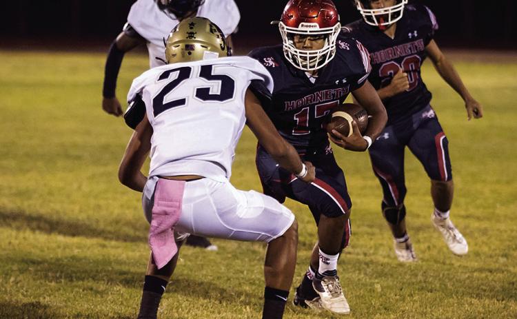 Aspermont Senior, Calob Castaneda, stars down a Jayton Jaybird defender as he carries the ball downfield towards the end zone