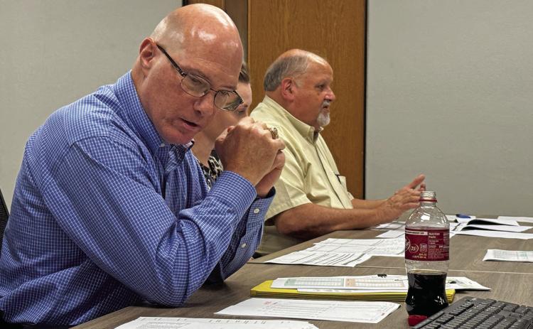 Tax appraisal experts Gary Zeitler and Rodney Kret speak to Rotan ISD officials, hoping to explain tax value fluctuations the district has experienced during recent years. PHOTO BY MARK