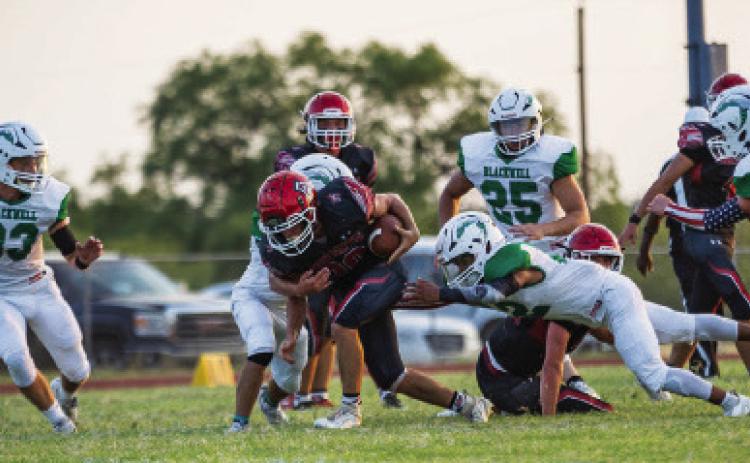 Aspermont senior Carson Guidry plows through Hornet defenders during their 30-14 season opener against Blackwell this past Friday. The Hornets will look to build a streak with a win against Southland this Friday night in Aspermont. PHOTO BY MARK MARTINEZ