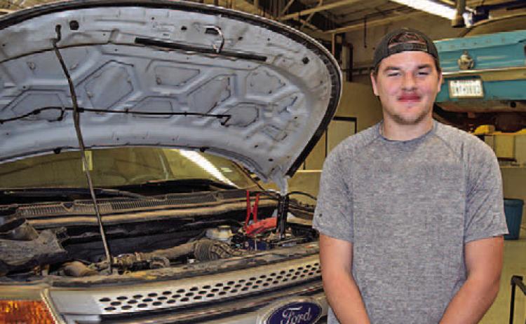 Photo caption: Bryce Block is using the skills he has learned in Automotive Technology at TSTC to work on his Chevrolet Camaro at home. (Photo courtesy of TSTC.)
