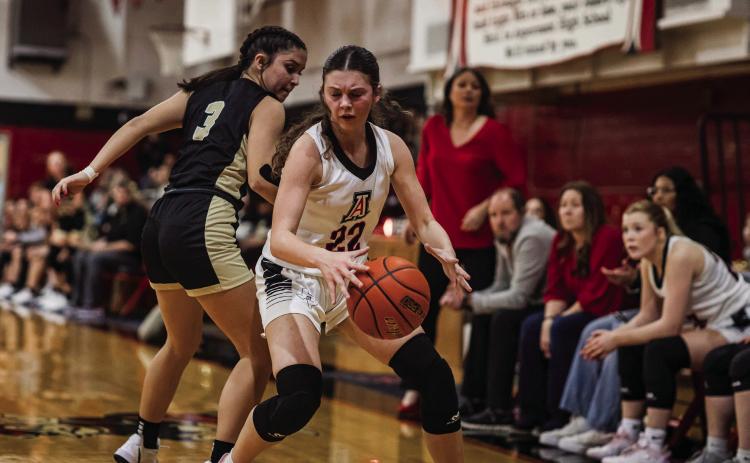 Aspermont sophomore Maleah Hecht weaves around a Lady Jay defender during the Lady Hornets' 31-35 loss to Jayton last Friday night. The loss to the Lady Jays evens up their series against each other at 1-1 in a fight for first place in district. They will travel to Hamlin this Friday night for a 2nd district bout with the Lady Pipers. Photo by: Mark Martinez