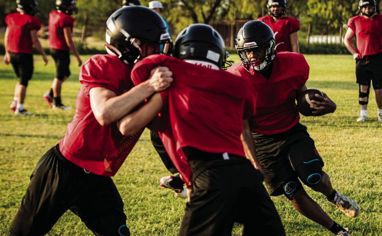 Junior Isaiah Johnson darts through a gap during Aspermont's morning practice. Photo by Mark Martinez.