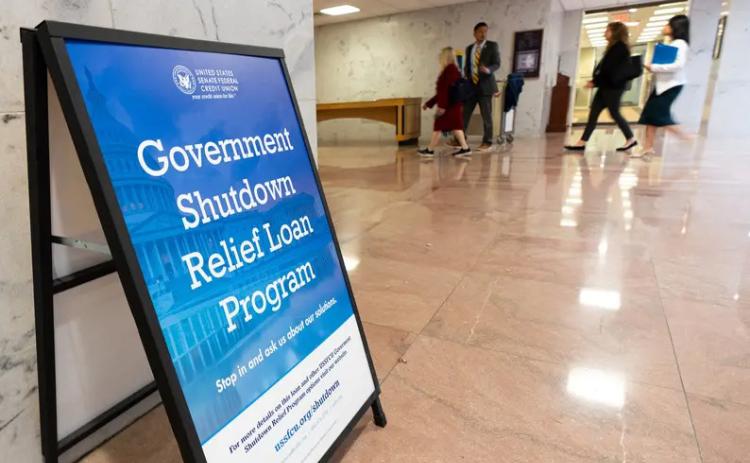 A sign advertises a government shutdown relief loan program outside the United States Senate Federal Credit Union branch office in the Hart Senate Office Building in Washington on Tuesday, Sept. 30, 2025. Credit: Bill Clark/CQ-Roll Call/Sipa USA via REUTERS