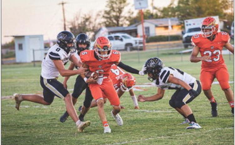 Rotan Sophomore Jose Garza weaves through Cowboy defenders during the Hammers 44-39 win over Woodson last Friday night. Photo by Mark Martinez