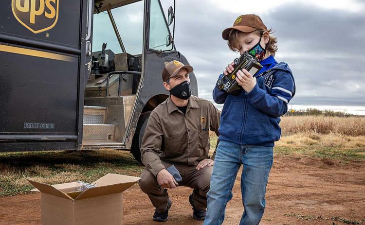 Conrad inspects the die-cast version of his new UPS truck, part of a special delivery received from James Klozinski, aka The Present Guy.