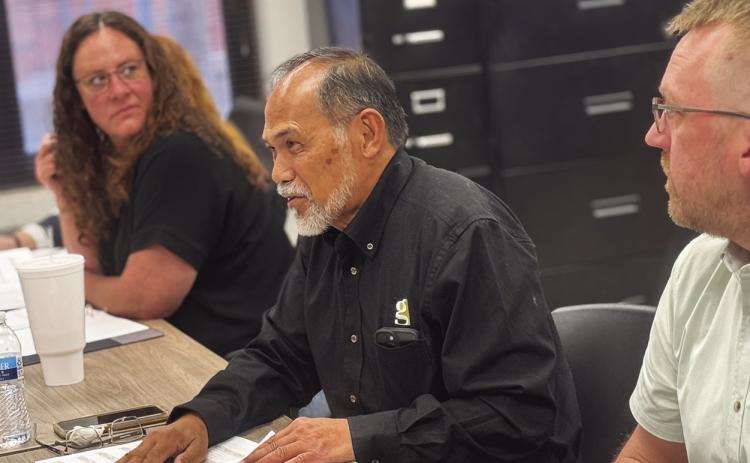 Gallagher Construction representative Nathan Umanos reviews the bid package and project “total sheet” with Rotan ISD trustees during the February board meeting as Rotan ISD Principal Jody Helms and WRA Architect Alex Fedrick listen in.
