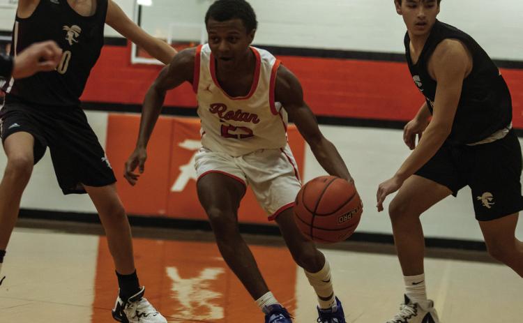 Rotan senior Jordan Daniel weaves through Pirate defenders during the Hammers 42-80 loss vs. Eula over the Christmas break.