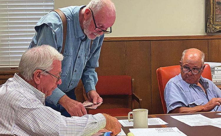 Stonewall County resident, Flynn Simmons points out areas of erosion along CR 410 with County Judge Ronnie Moorhead as Commission Gary Myers looks on.