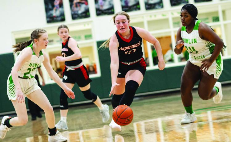 Aspermont senior Raelynn Bradley fast breaks through a pair of Lady Piper defenders during the Lady Hornets 52-21 win over Hamlin this past Friday night. The Lady Hornets remain stern in their battle for a top spot in district play. They will host the Rule Lady Bobcats this Friday at 6pm in Aspermont. Photo by: Mark Martinez