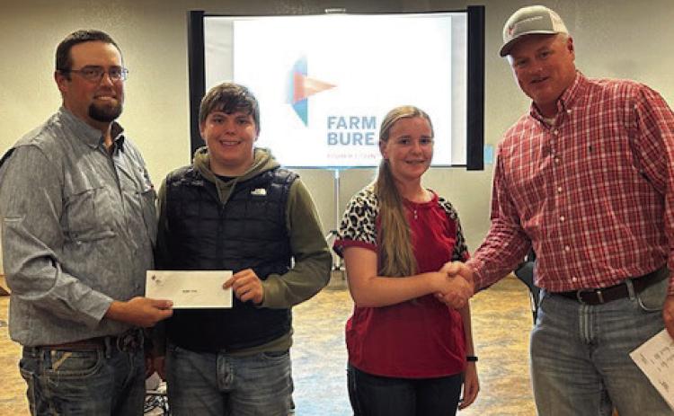 Roby FFA- left to right - Seth Kiker, Brycen Cole, Gemma Noell with FCFB president Steve Estes