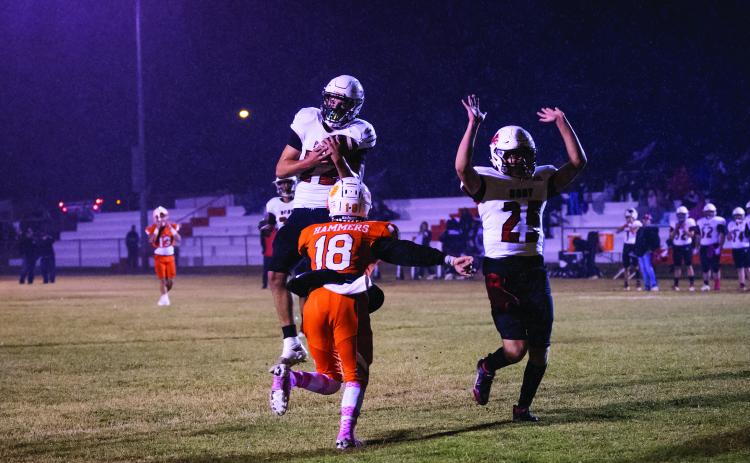 Lion senior Ethan Hernandez picks off a pass in the pouring rain intended for Hammer reciever.
