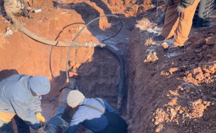 Aspermont City workers and citizen volunteers work tirelessly in icy water and arctic temperatures to repair the city's water supply. (Photo Curtesy of Brandon English)