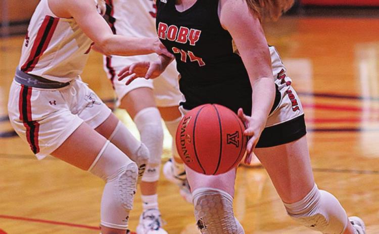 Roby's Laney Stewart works her around the Lady Hornet defense. Photo by: Tricia Hurt