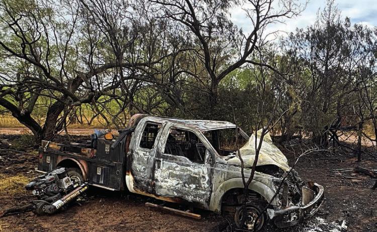 The charred remains of a pickup truck lie off Hwy 180, surrounded by scorched vegetation. Last week, the driver, Kyler Covington, was involved in a high-speed chase and gunfire incident after a motorist accidentally struck his dog. PHOTO BY JEFF HURT