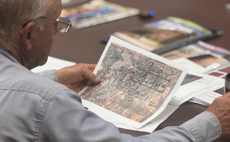 Stonewall County Commissioner Gary Myers reviews the site location of the proposed Crusoe Data Center during a May meeting.