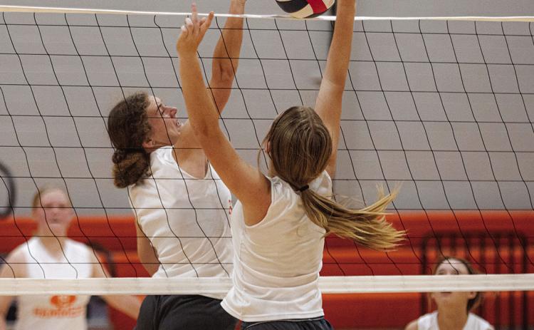 Senior Tylee Fillingim meets Freshman Talyn Lewis at the top of the net. Photo by Mark Martinez