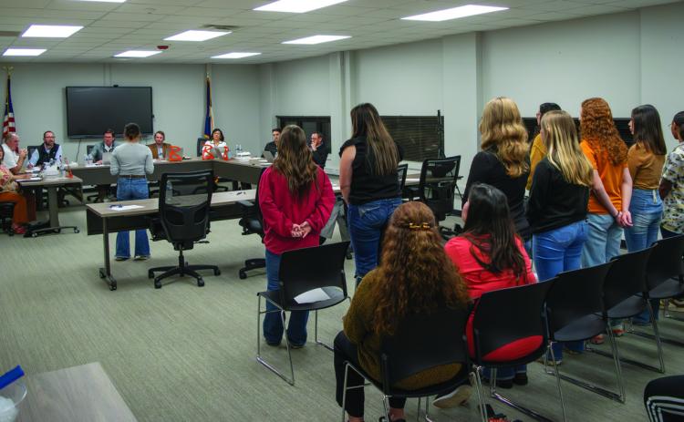 10 potential team members and a room full of supporters listen along as students and parents urge Rotan ISD Trustees to help students compete in the upcoming softball season.