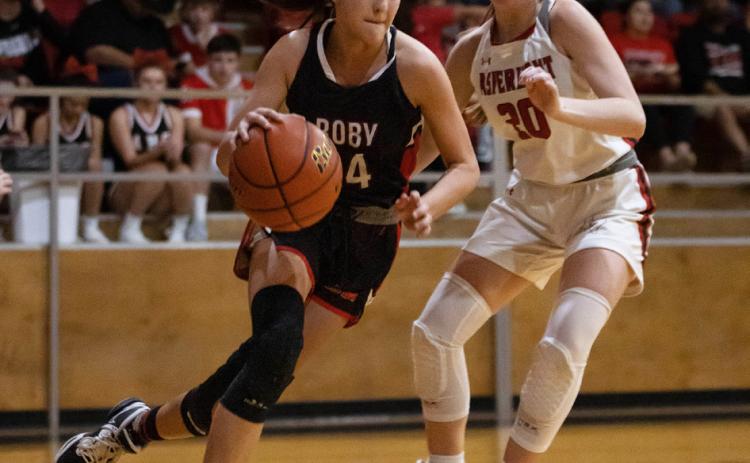Lady Lion Hailee Garmer works to get around Aspermont's Kelly Lowack during the Roby's 36-24 win over Aspermont. (PHOTOS BY MARK MARTINEZ)