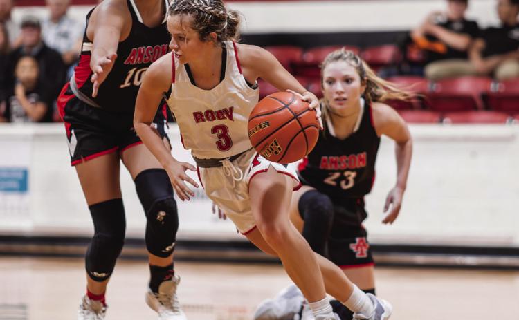 Left: Roby Senior Chasity Benson weaves passed Lady Tiger defenders during the Lady Lions' narrow 48-53 loss to Anson Tuesday night. The Lady Lions will next take the court against Jayton in Jayton at 5pm this Friday. PHOTO BY: TRICIA HURT
