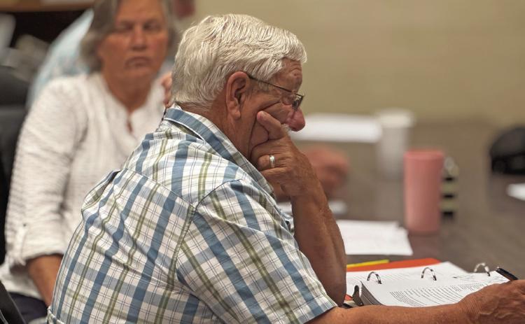 Rotan City councilman Loyd Green reviews the fist reading of proposed ordinance in August that will increase the city’s water rates