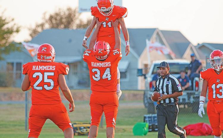 Rotan's Payton Carrillo lifts up teammate Grayson Jeffrey after scoring a touchdown. Photo by: Mark Martinez