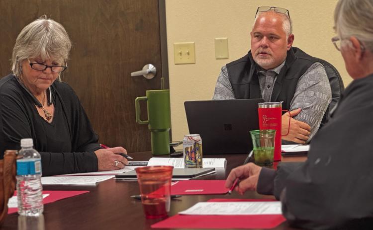 Stonewall Hospital District CEO Michael Moorhead and board president Ellen Abernathy listen in as district CFO Lewis Robbins (not pictured) delivers current financial reports as the district works to expand services.