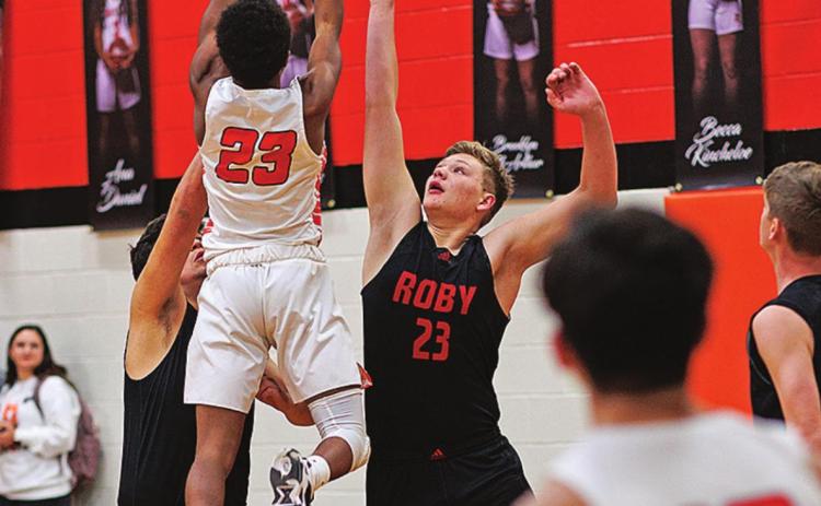 Jordan Daniel takes a high shot over two Lion defenders during the Hammers 53-38 win over Roby. Photo by: Tricia Hurt